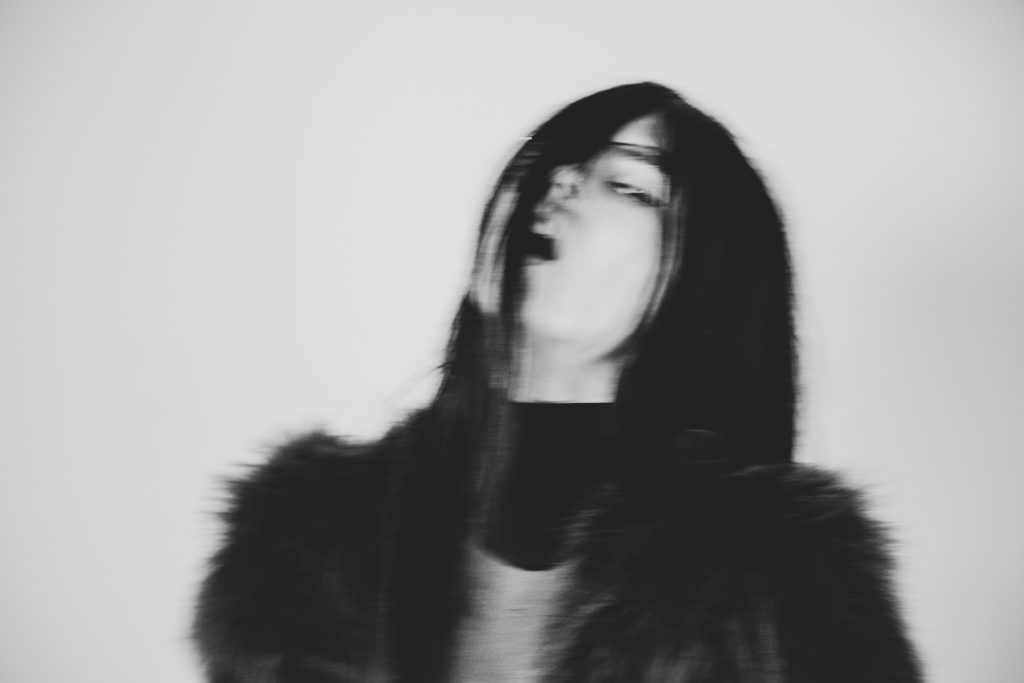 black and white photo, women, black hair, fur coat, blurry, mysterious